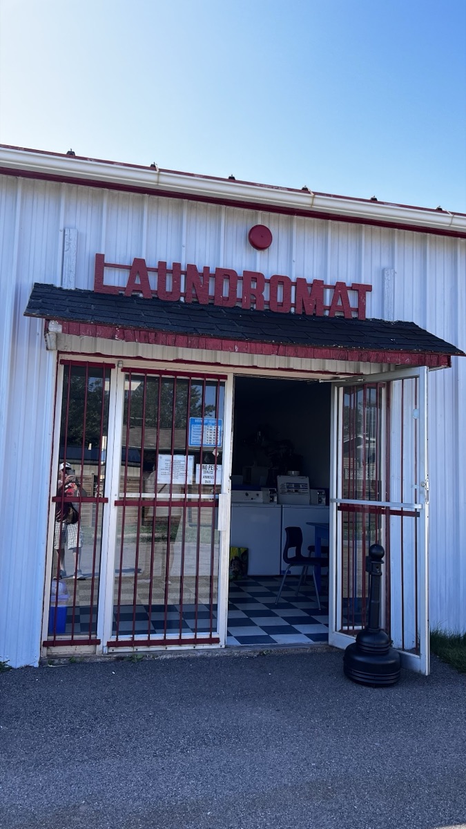 The laundromat entrance with its red LAUNDROMAT sign
