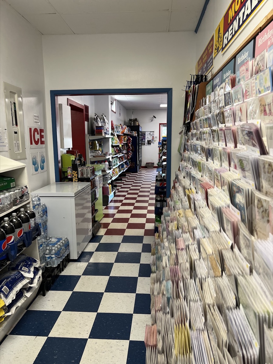 A hallway lined with greeting cards leading into the store